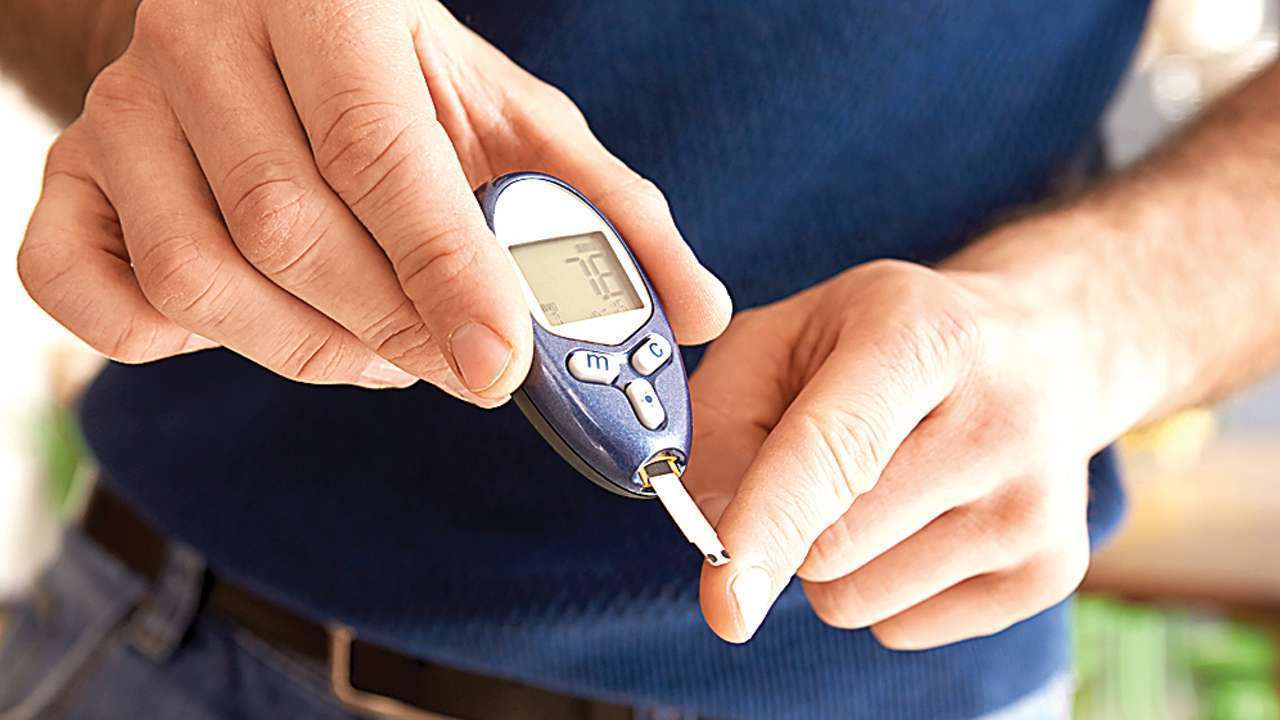 Gundry Health man holding a diabetes meter lowq