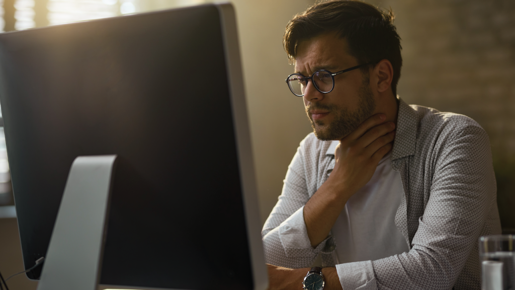 man with glasses having sore throat