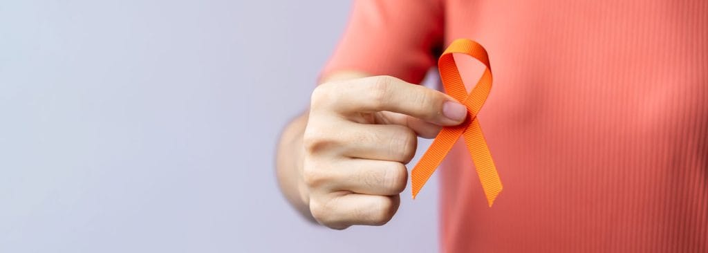 man holding an orange ribbon