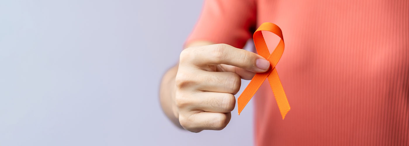 Gundry Health man holding an orange ribbon
